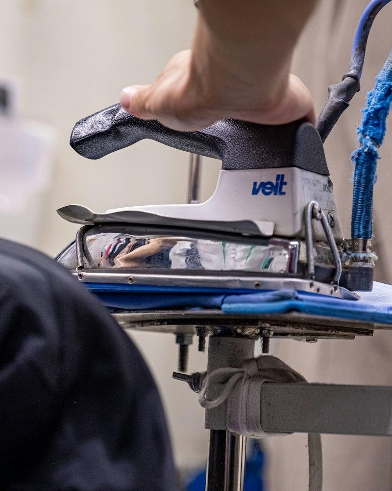 A specialist pressing a garment